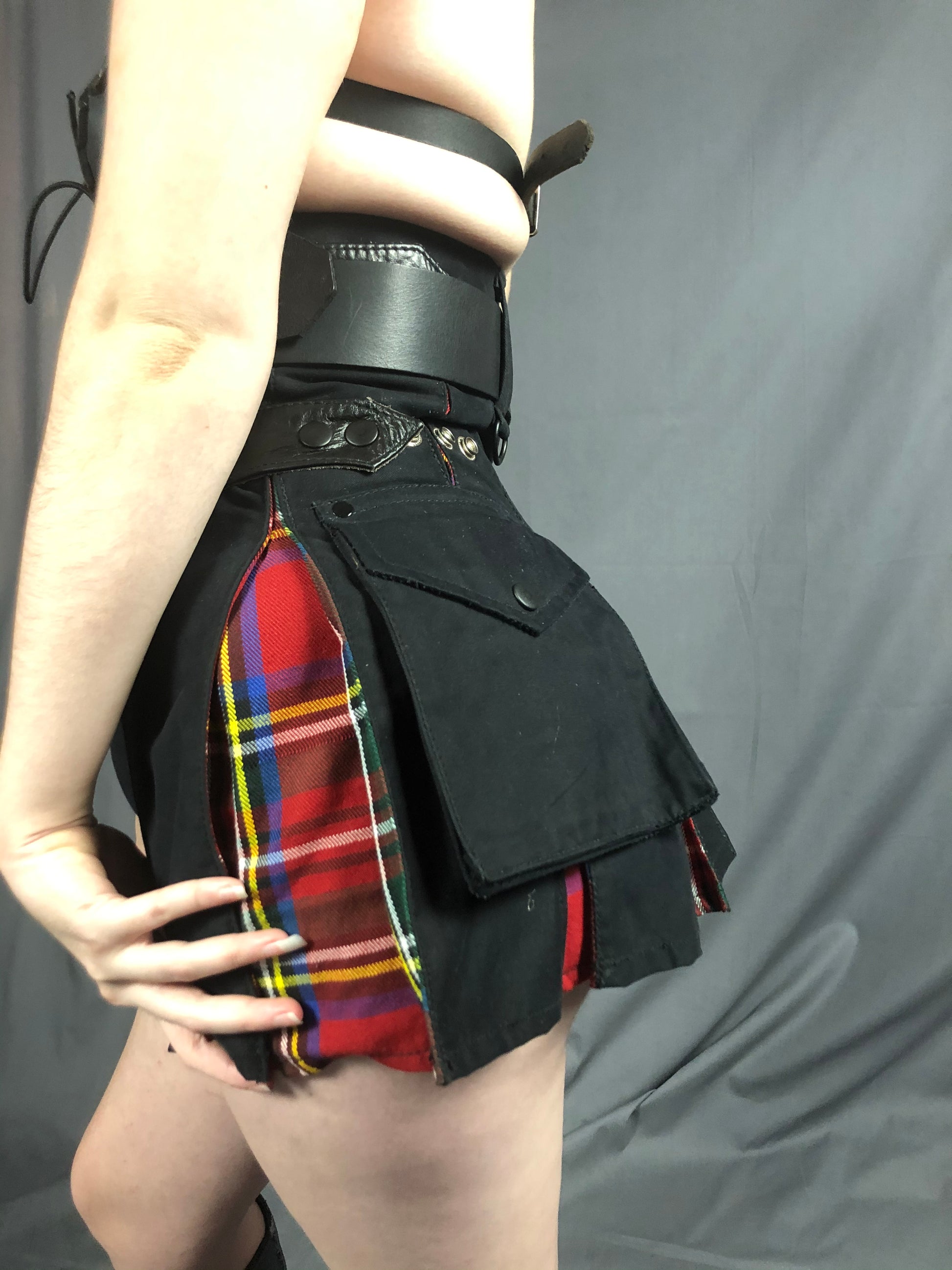 The left side of the Black and red tartan Mini Contrast Pleat Cargo Kilt.