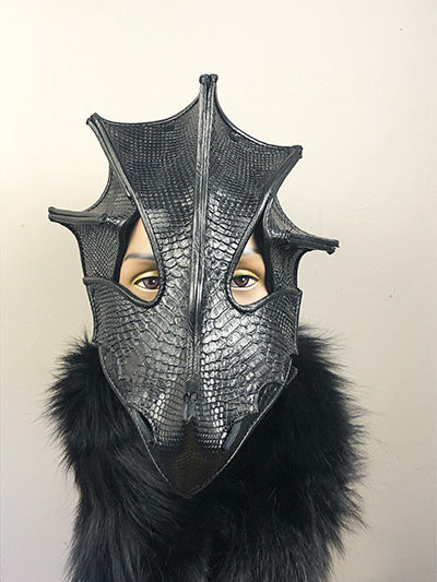 forward facing black leather dragon mask on a mannequin
