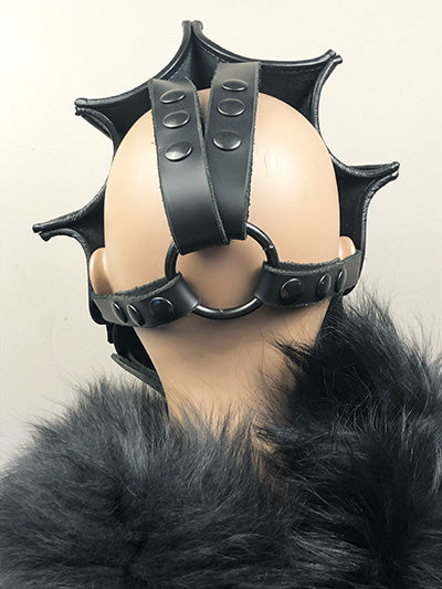 backward facing black leather dragon mask on mannequin