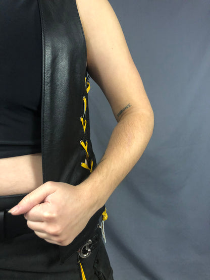 Closeup of the left side of the front & back lace cowhide bar vest with yellow laces.