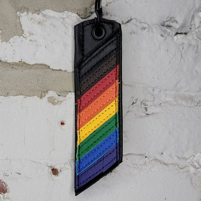 Rainbow Philly Pride Flag Keyring Against a Wall