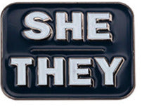 SHE/THEY grey background with white lettering enamel pronoun pin