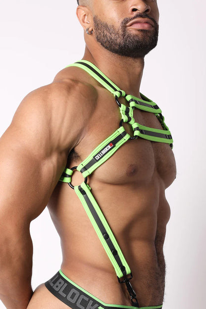 A masculine looking model showing the right  side of the neon green High Bar Neoprene Suspender Harness.
