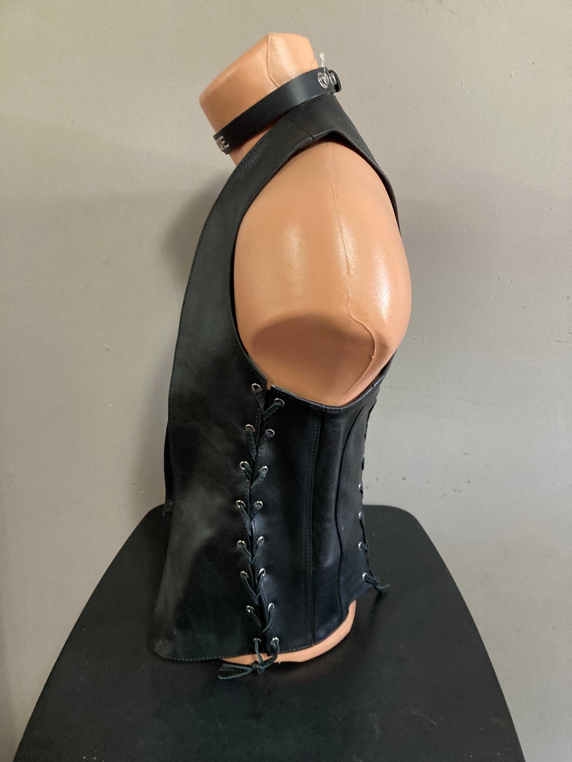 A mannequin showing the left side of the vest with side laces.