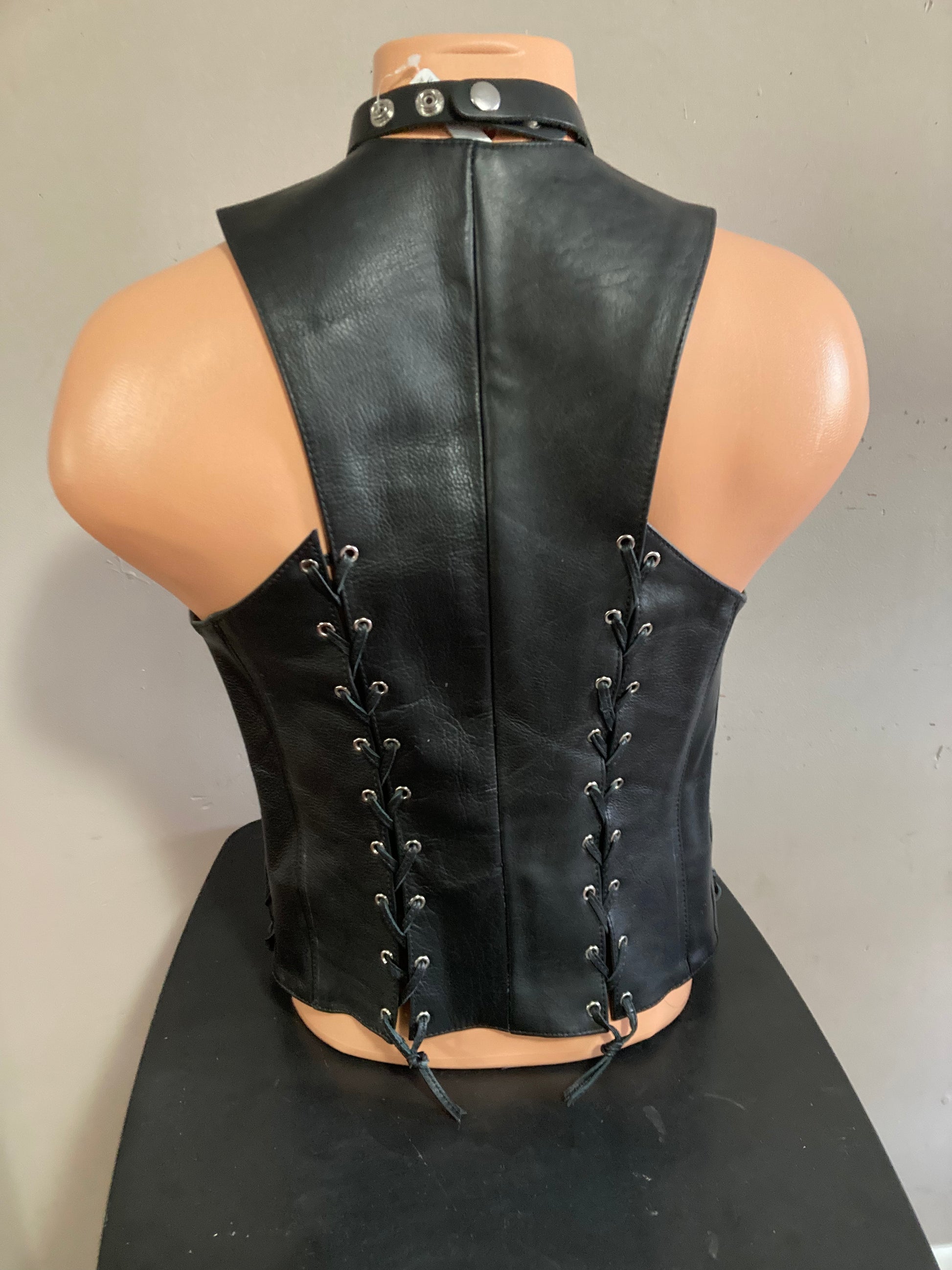 A mannequin showing the back of the vest with 2 back  laces.