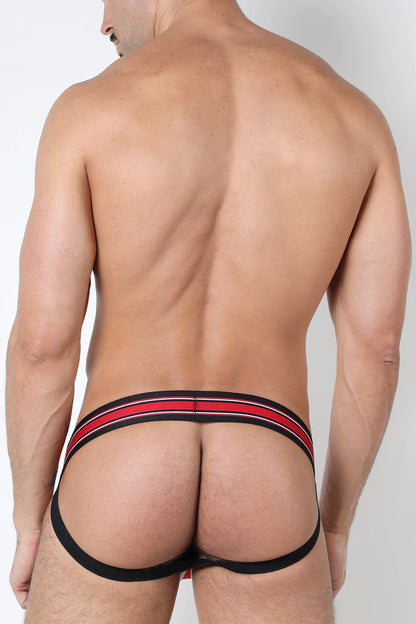 A masculine looking model showing the back of the red Kennel Club Atlas Jockstrap.