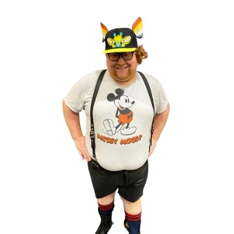 Front view of classic leather suspenders on model wearing a white mickey mouse t-shirt, leather shorts and Cap with 2 K-Ear Snaps with leather pride K-9 ears and leather boots with red socks.