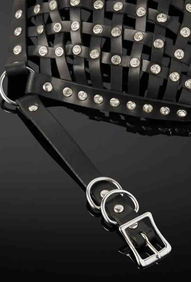 A closeup of an O-ring, rivets and straps along with the buckle and strap closure of the Opulanta Obscura Luxury Leather Strapped Mask.