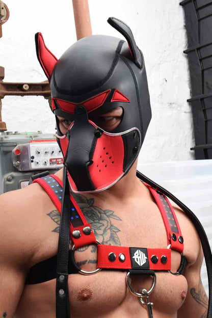 A model in a red chest harness wears the red Poundtown Glow Pup Hood.