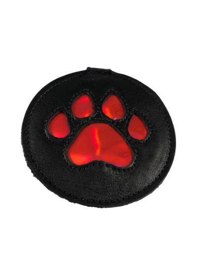 The black leather pup paw medallion with metallic red paw design.