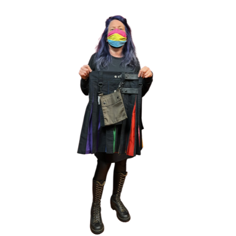 Model holding pride flag cargo kilt with detachable brown kilt pocket.