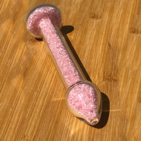 Rose quartz crystal healing stone basix delight dildo on a bamboo board.