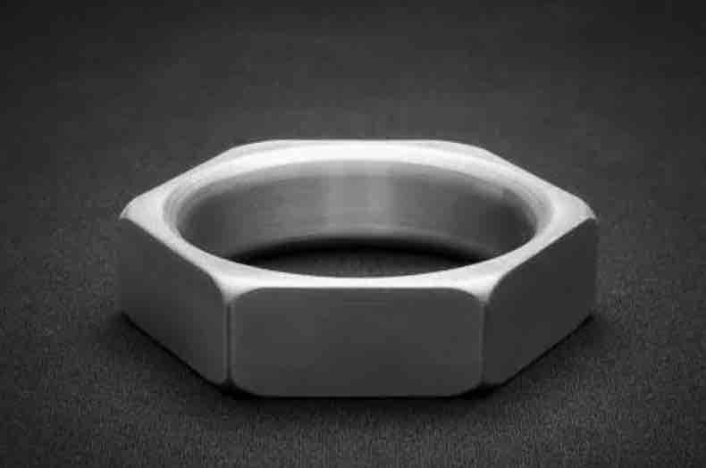 An Aluminum Cock-Nut Cock Ring on its side.