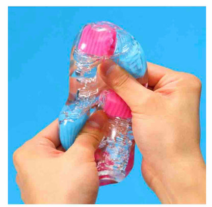 Two hands squeezing the stroker to show how soft and pliable it is.