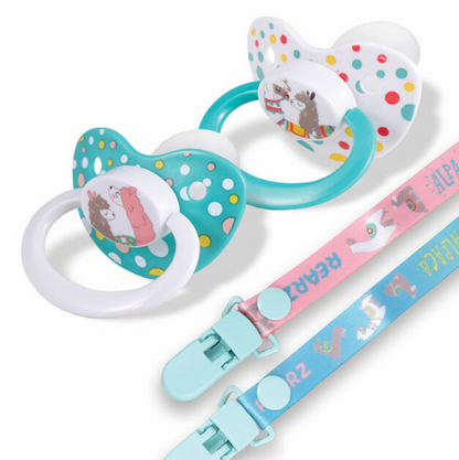 Two Rearz Alpaca Character Pacifiers with their clips laid beside them.