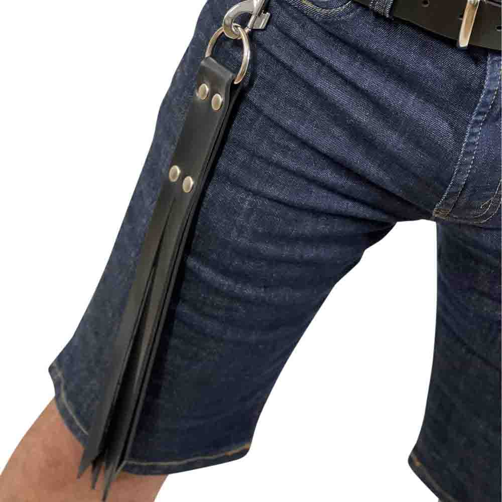 The Rubber Split Slapper hanging from the waist of a model wearing jean shorts.