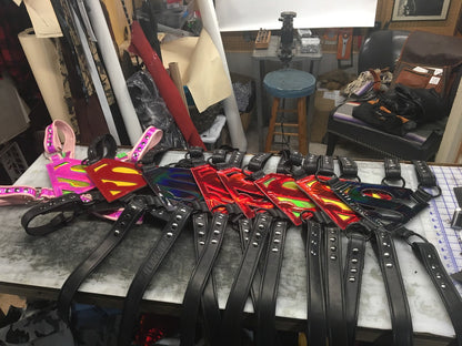 A variety of Super Harnesses laying on a work table.
