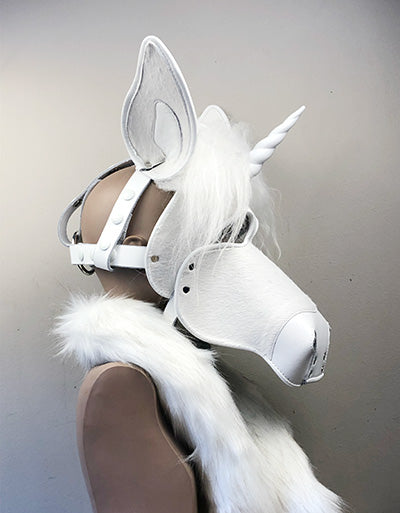 White leather unicorn mask on a mannequin, right side view.
