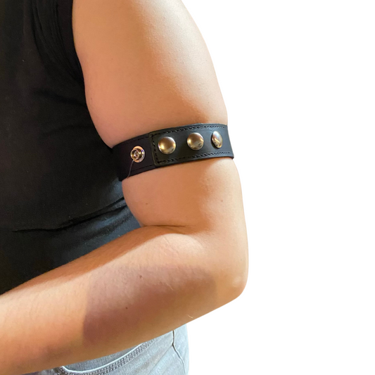 A model's arm wearing the 1.25" Wide Armband with Snaps around their bicep.