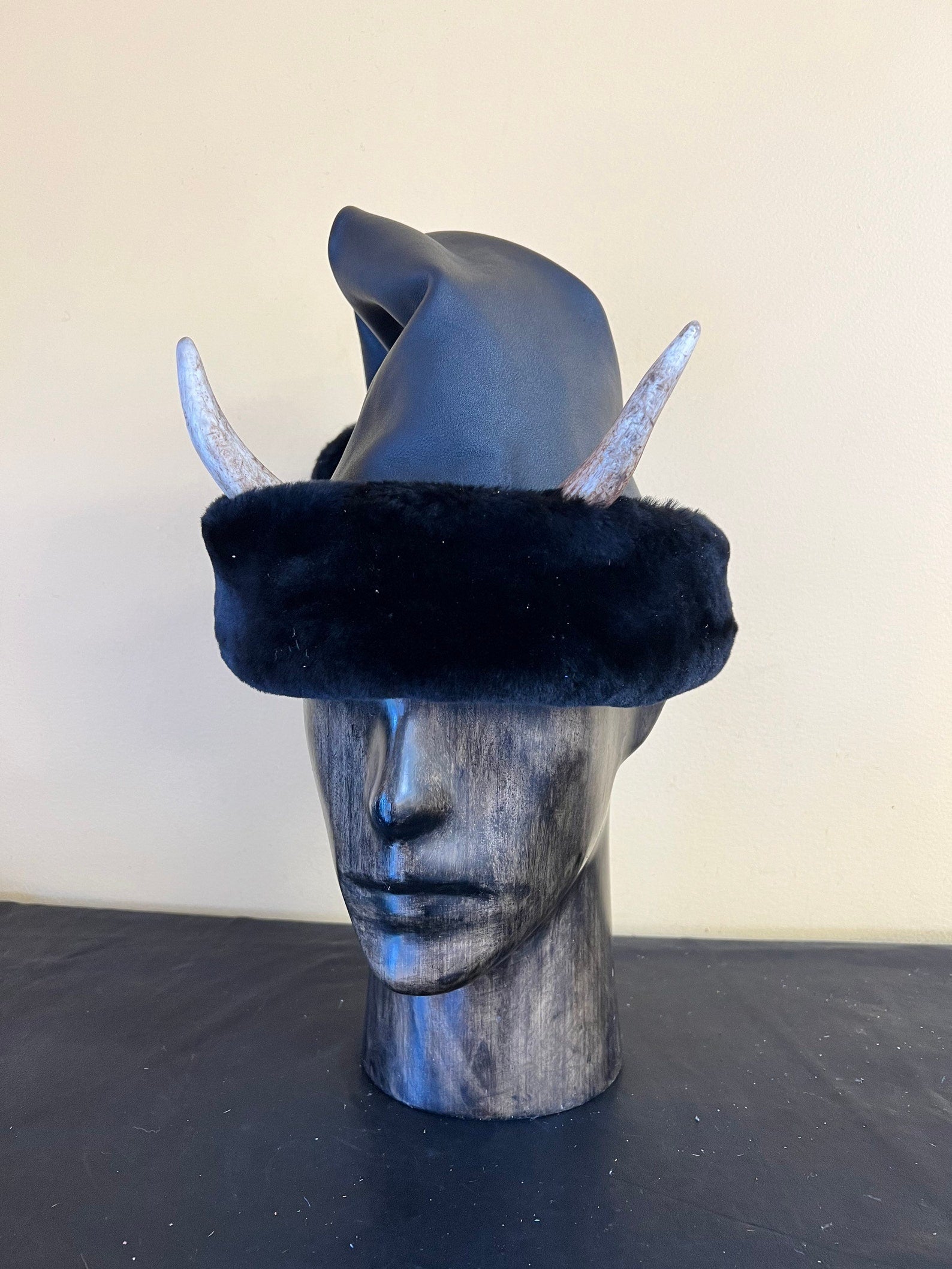 Leather Santa Hat w/ Krampus Horns in black leather with black fur on mannequin