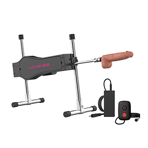 The Lovense Bluetooth Sex Machine with a dildo attached to the end of it next to its charging cables.