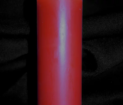 A close up of a red candle.