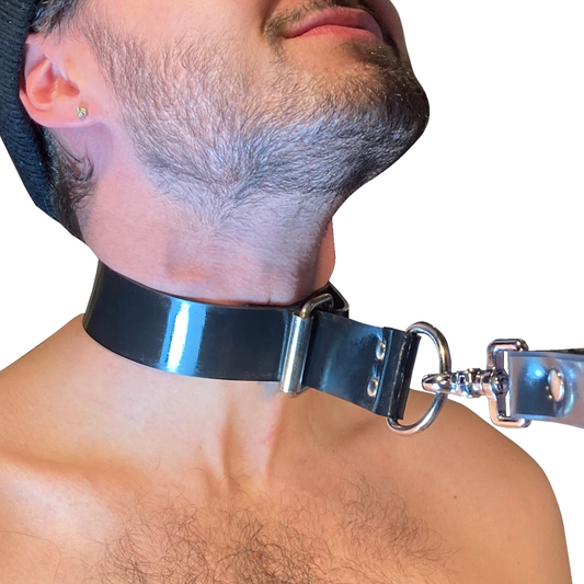 A masculine model wearing the Rubber Choker Collar, with a leash attached pulling the collar tight.