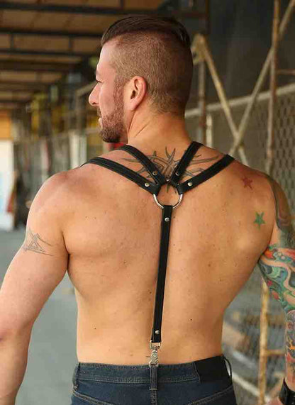 Shirtless model wearing jeans and showing the back of the Leather Double Strap Suspender Harness.