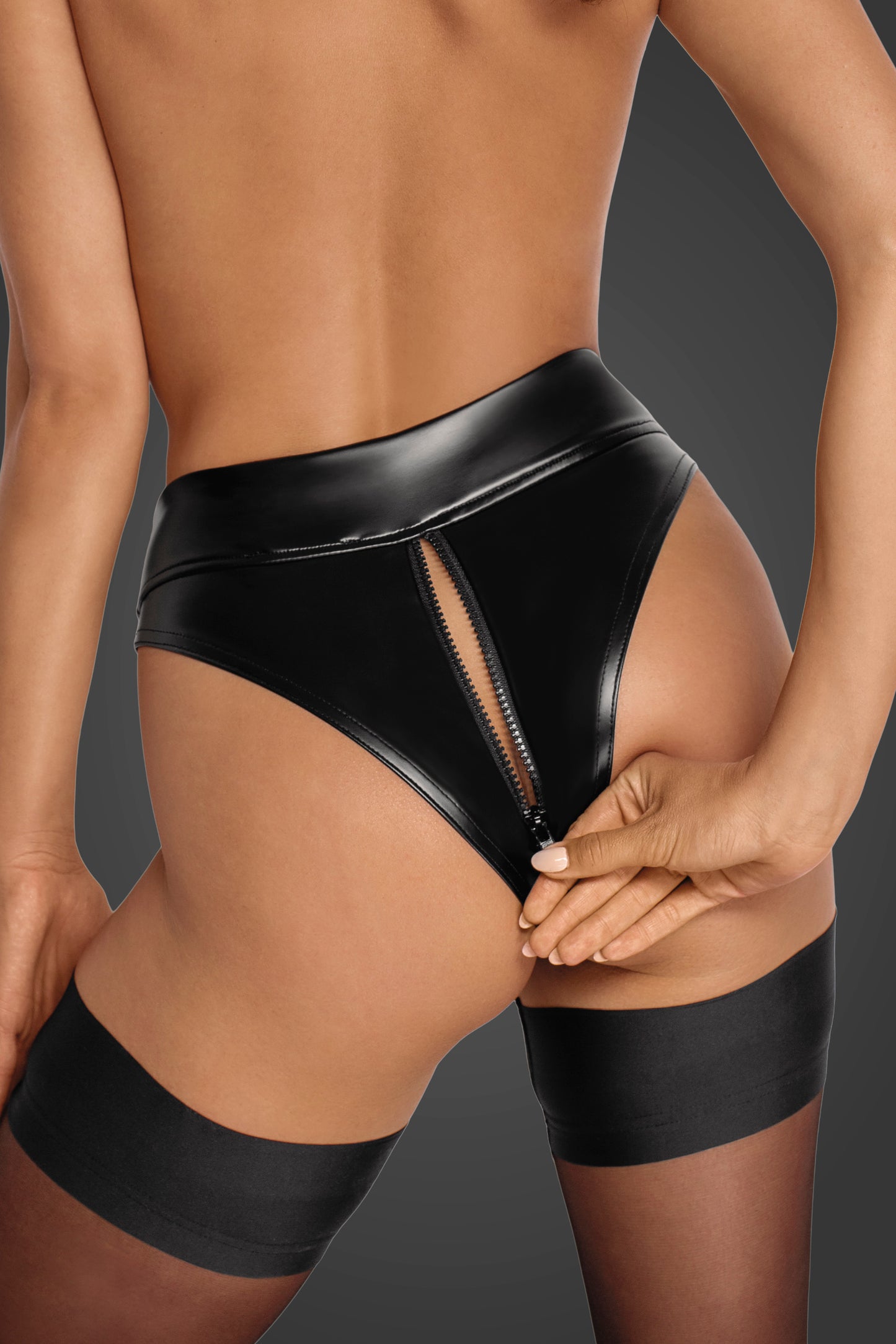 A feminine model shows the back of the Power Wetlook Panties with her hand unzipping the 2 Way zipper.