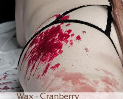 Cranberry candle wax melted on a model's body.