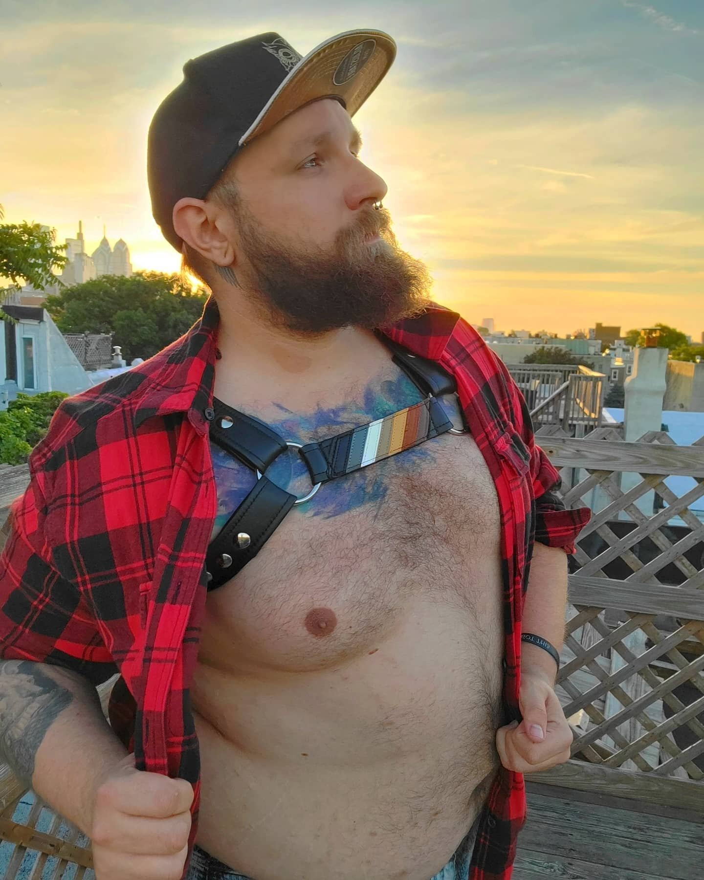 A model showing the front of a harness with the Bear Pride Flag Center Strap.