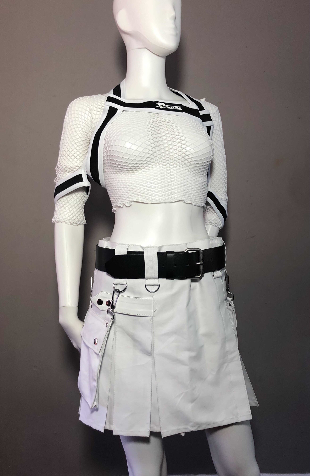 White Mini Heritage kilt on Mannequin with belt harness and net shirt, front view.