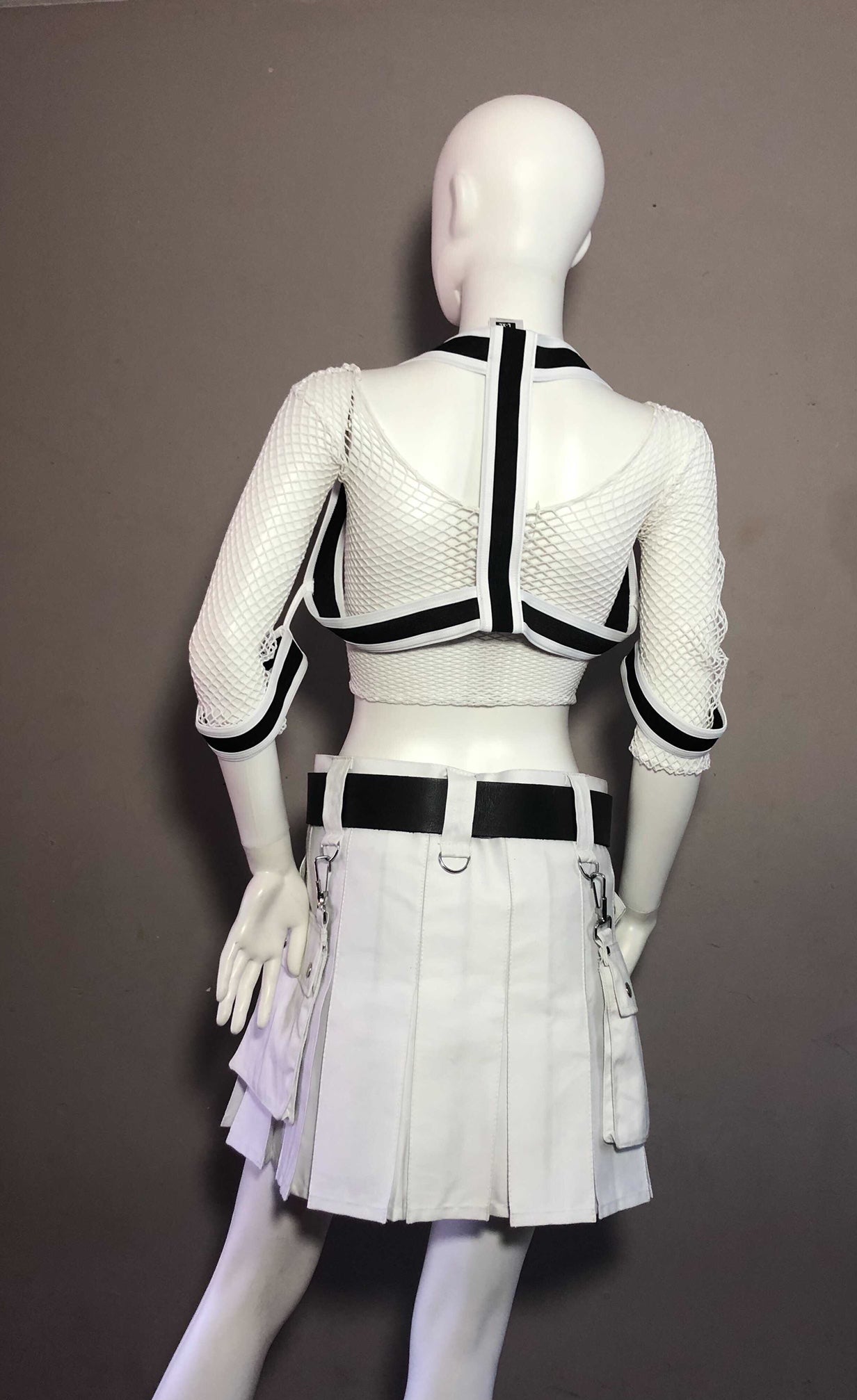 White Mini Heritage Kilt on Mannequin with harness and net shirt, back view.