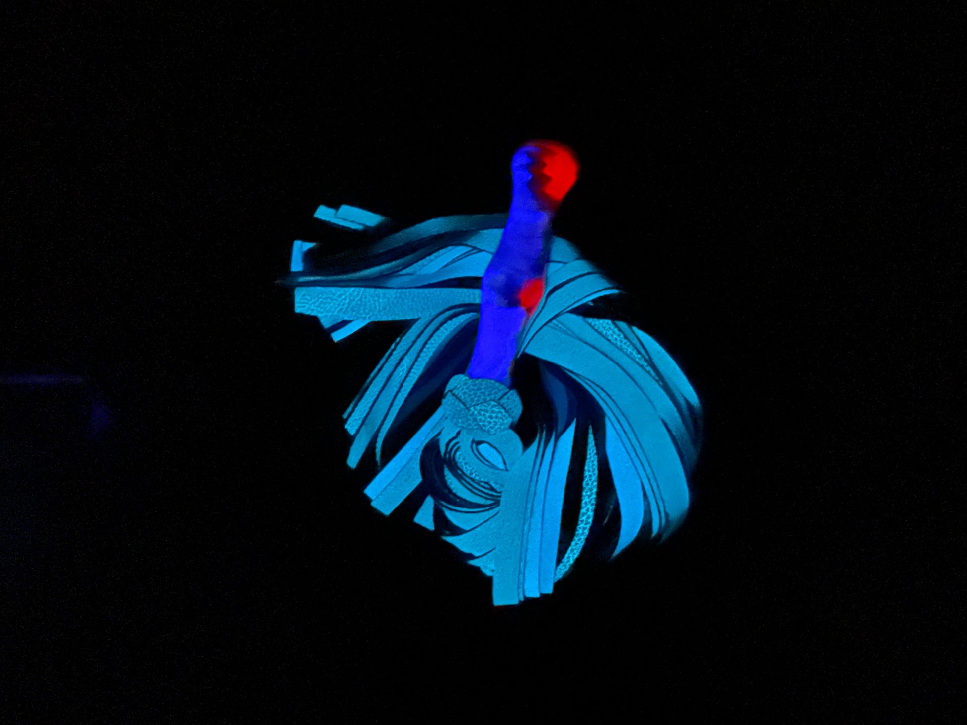 The blue and red handle Glow Acrylic Handle & Leather Flogger.