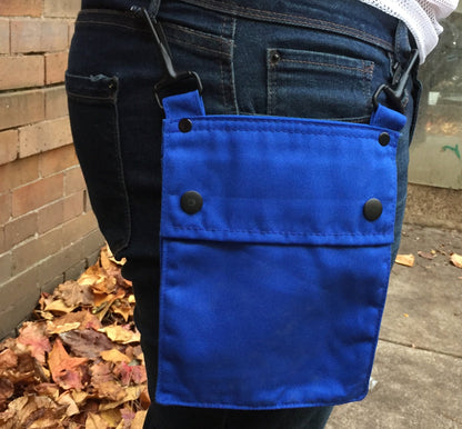 A model wearing the blue Detachable Pocket for Heritage Kilt hooked to their jeans belt loops.