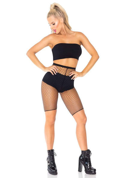 Model wearing black spandex industrial net biker shorts over black tight shorts and tube top.