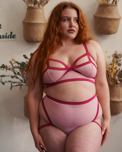 A model showing the front of the plus size raspberry fields Mesh Livi Thong, along with matching bralette.