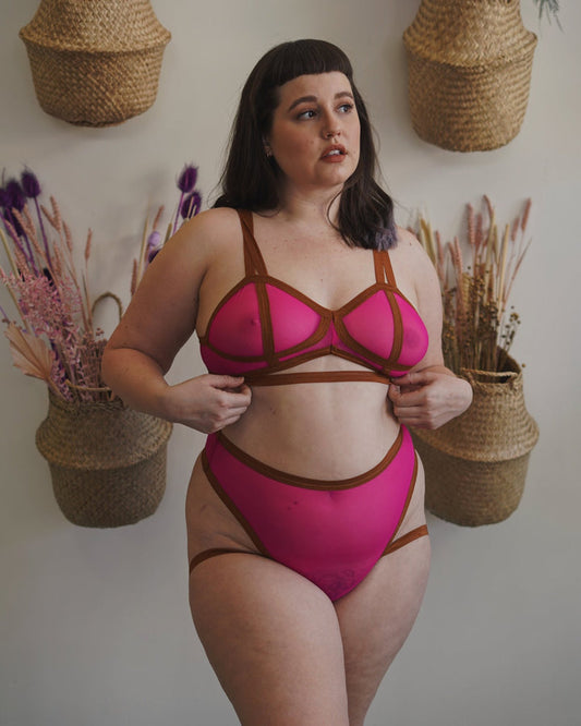 A model wearing the dragonfruit Mesh Vintage Soft Cup Bralette along with matching Mesh Livi Thong.