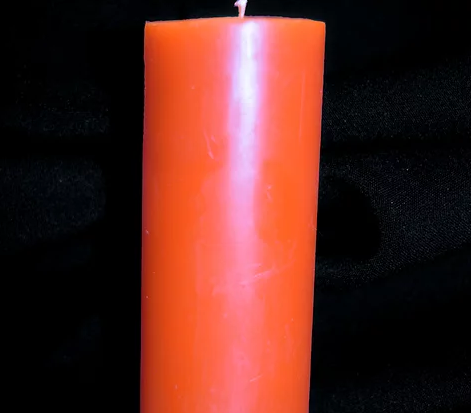Close up of an orange candle.