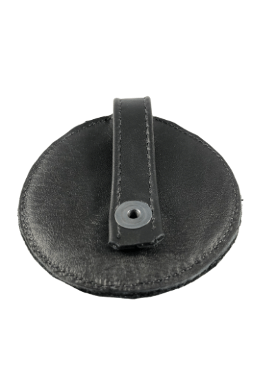 The back of leather harness pup paw medallion with a leather clip and metal snap.
