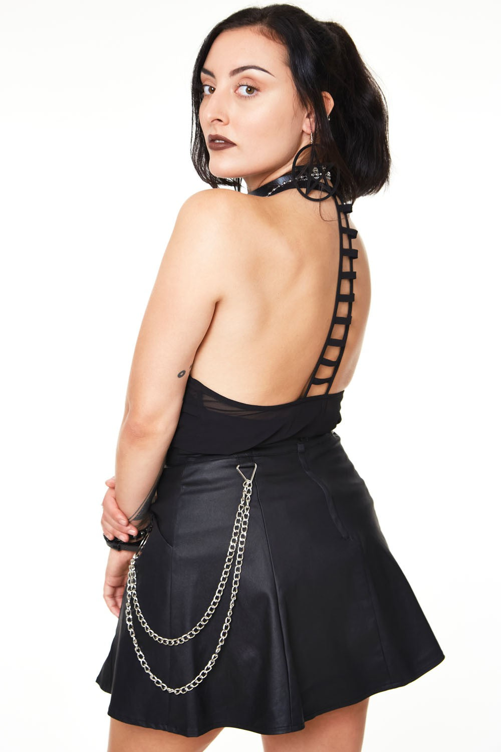 Rear view of the Vegan Leather Skirt with O-Ring and Chain Details.