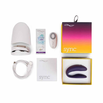 The The purple We-Vibe Sync with its remote, charging base, case, instructions, charging cable, lube sample and packaging.